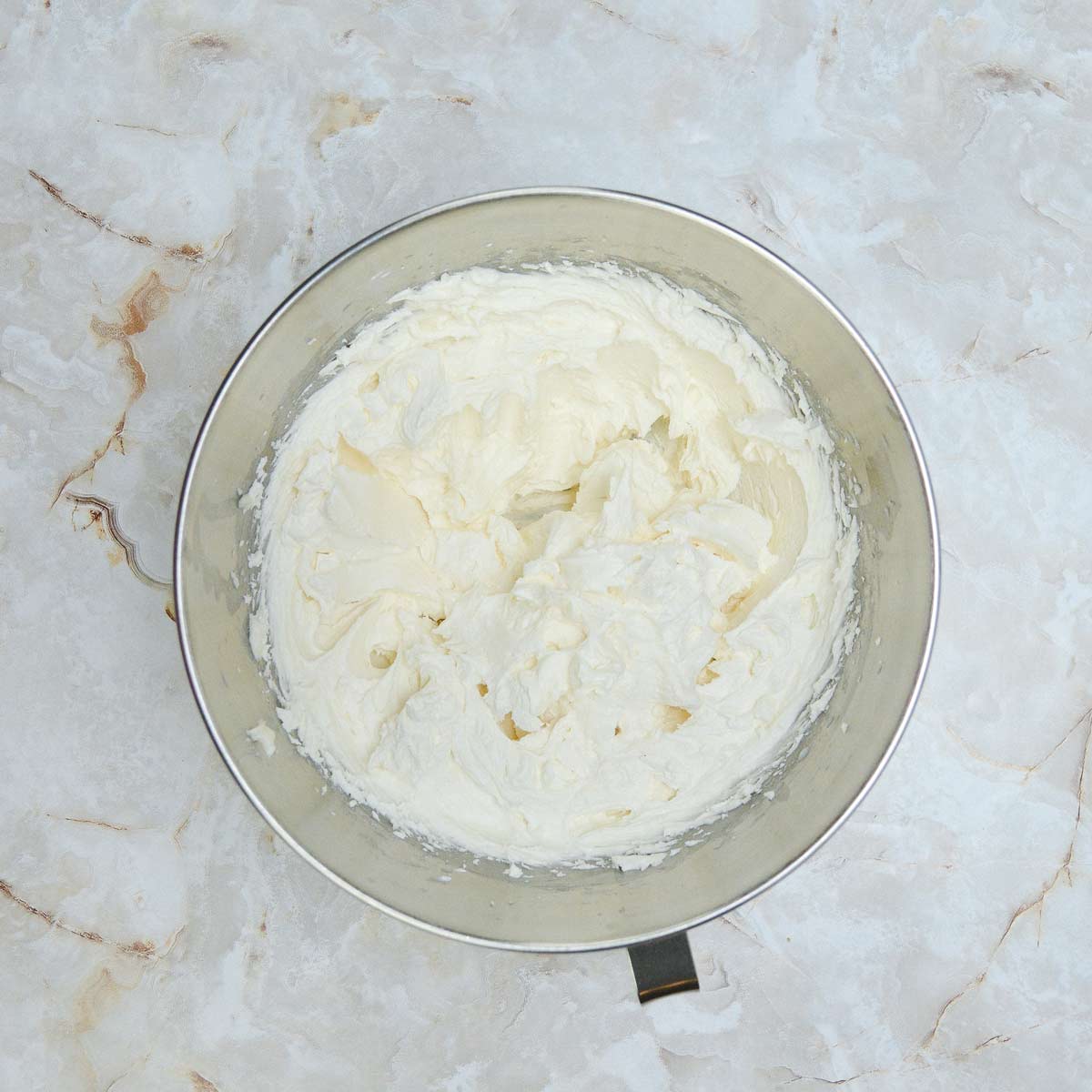 Fully mixed white buttercream frosting.
