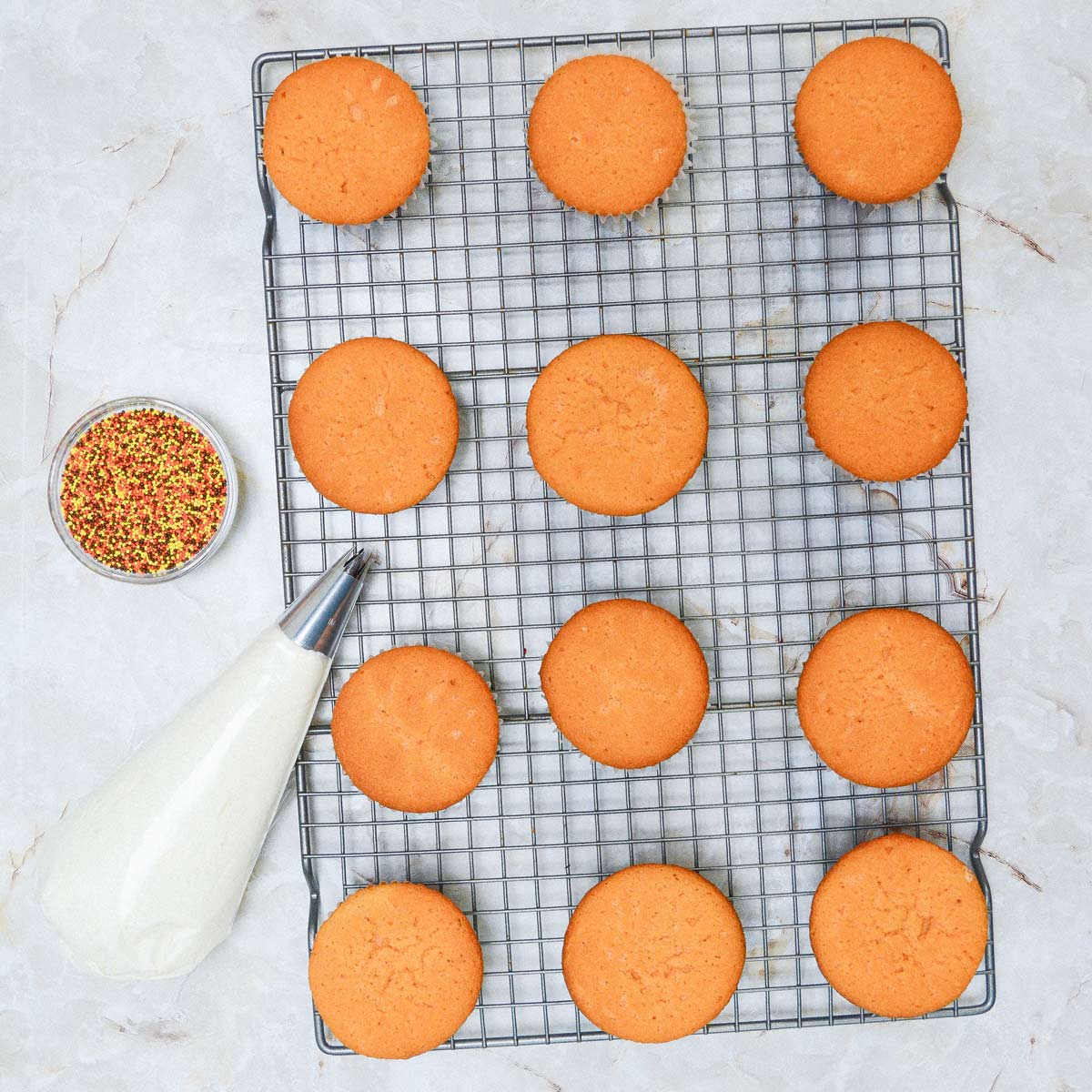 Baked cupcakes on a wire rack.