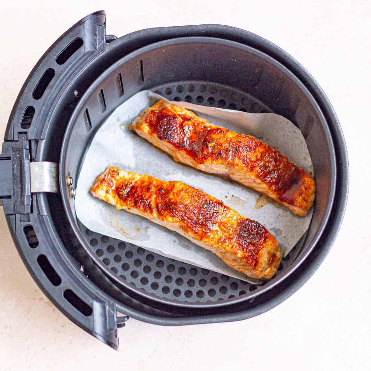 Fully cooked, golden brown salmon fillets.