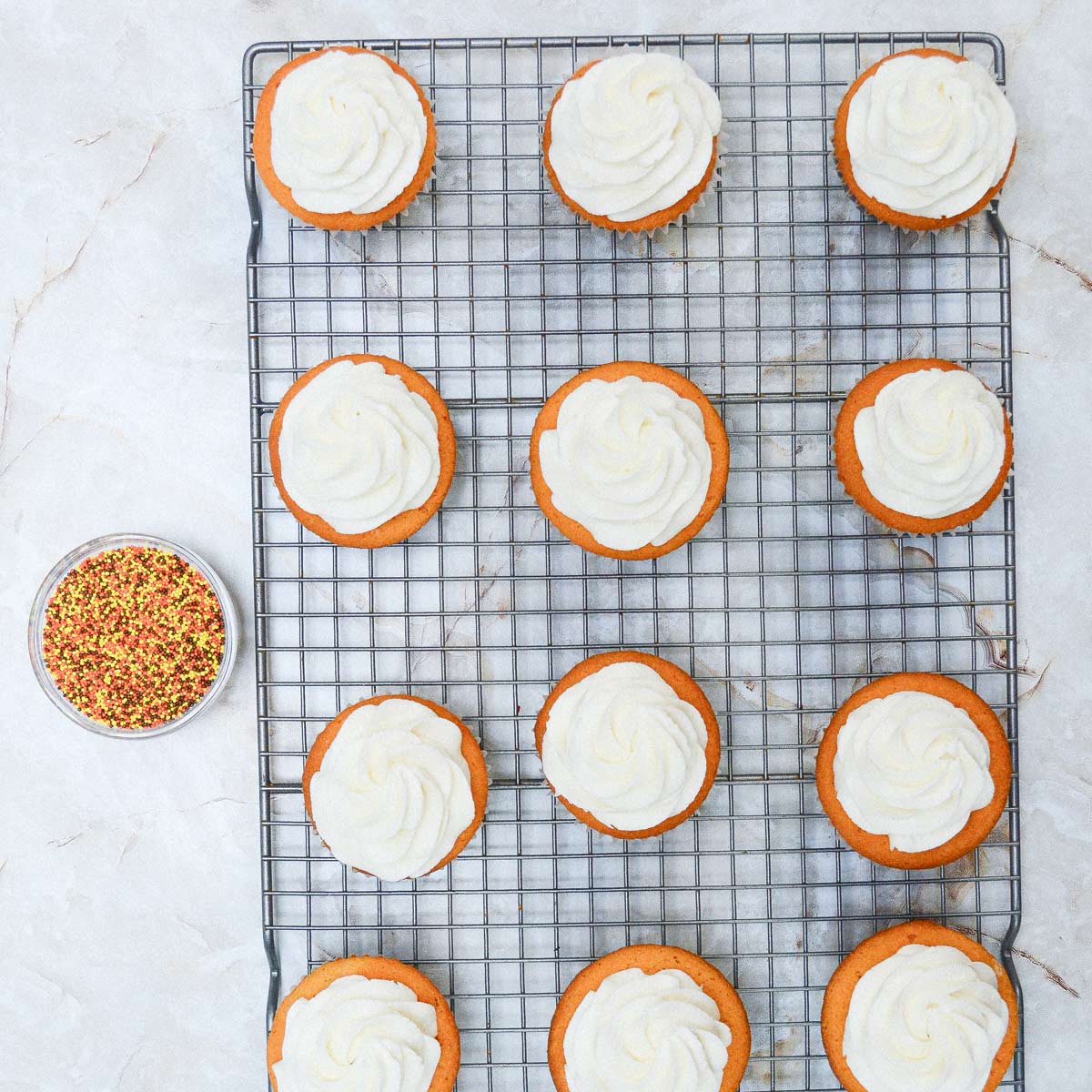 Frosted cupcakes on the wire rack.