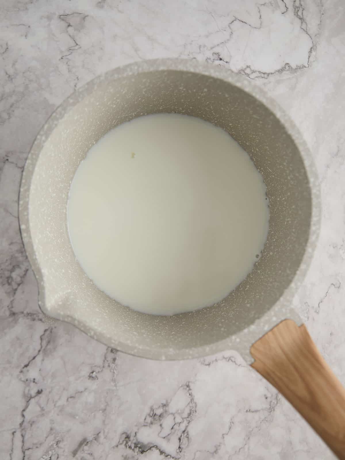 Pot with milk in it.