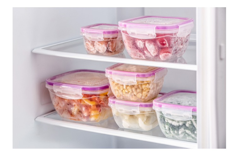 Freezer with containers of foor with pink lids.