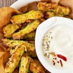 A plate of zucchini fries with mayo dip.