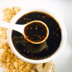 Bowl of teriyaki sauce with spoon.