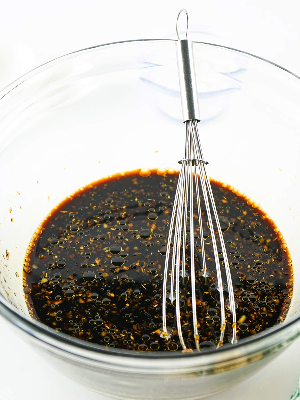Whisking the hot, thick, teriyaki sauce.