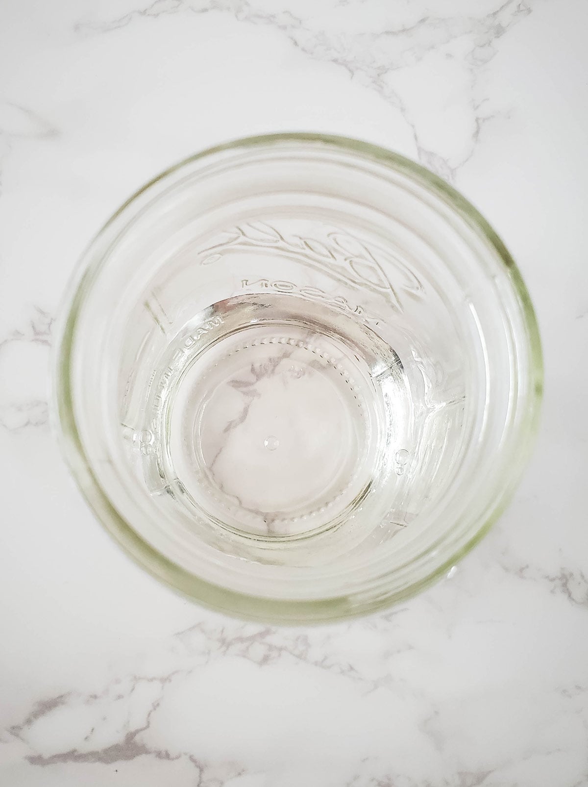 Vanilla syrup at the bottom of a glas Mason jar.