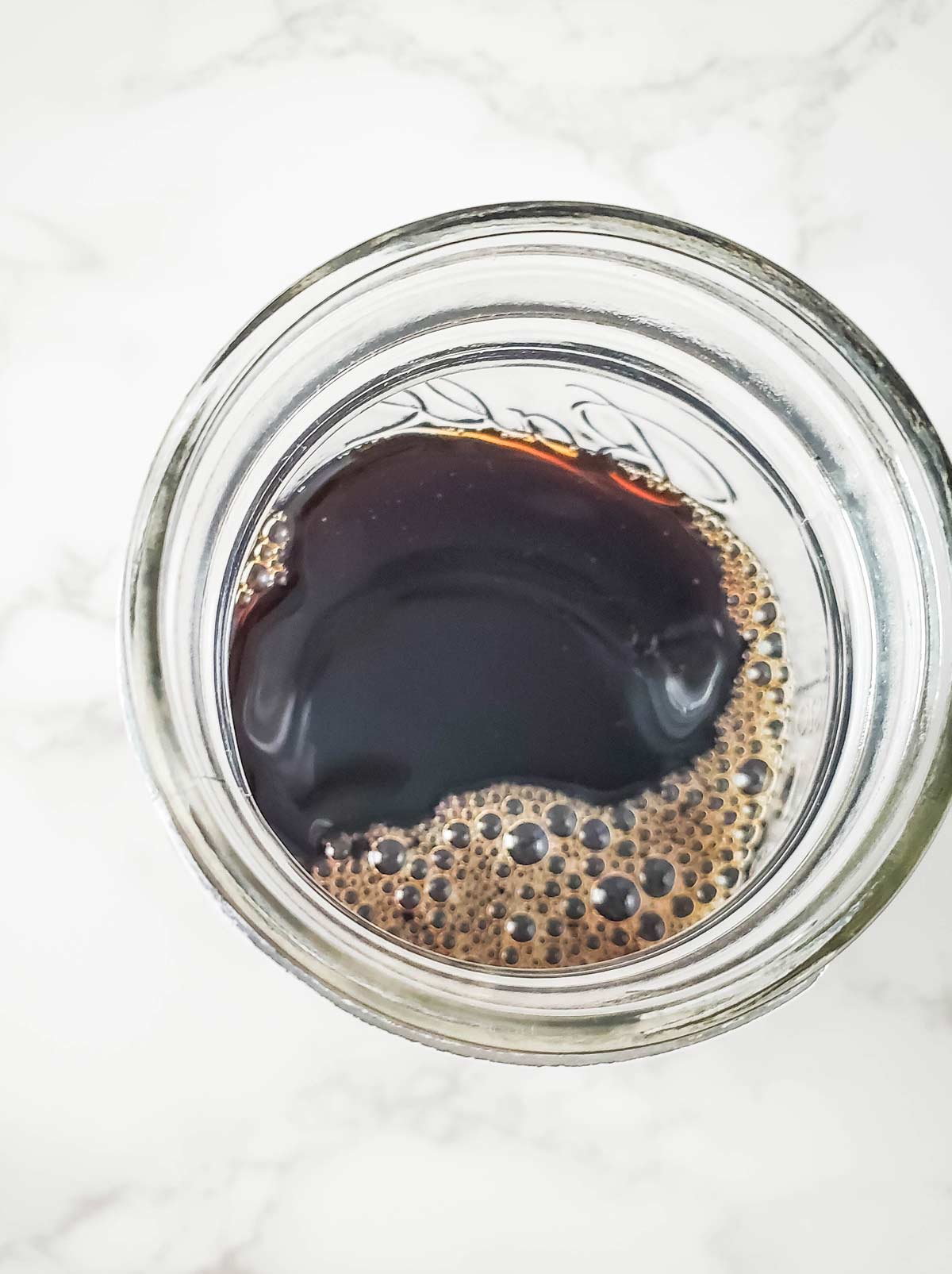 Cold brew coffee added to glass jar.