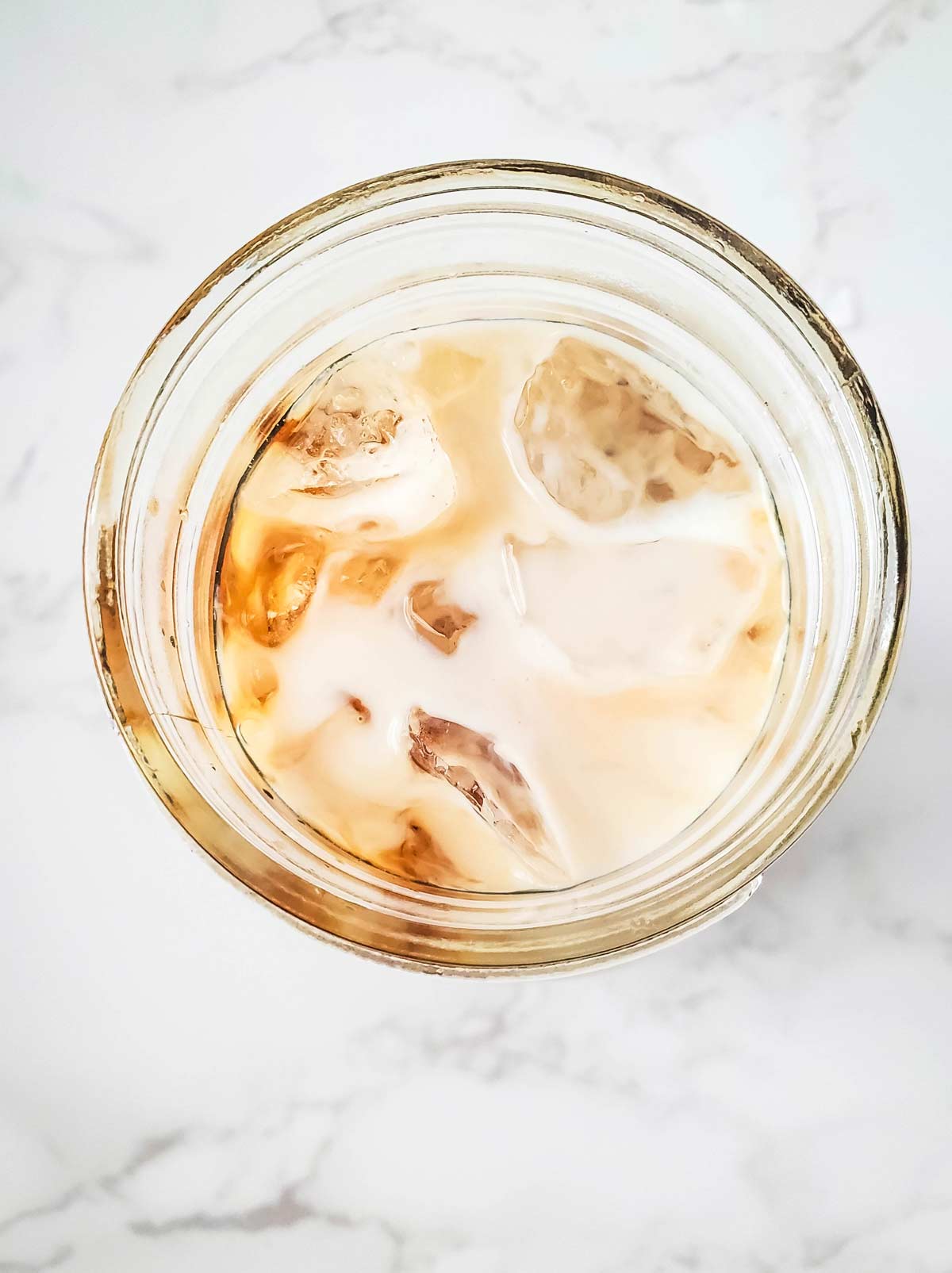 Glass jar with ready to drink iced vanilla coffee.