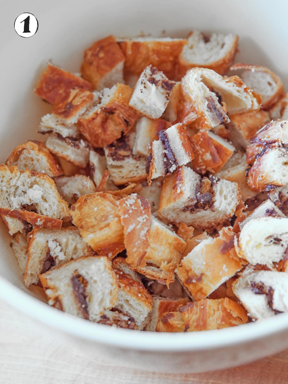 Bowl of cubed chocolate croissants.