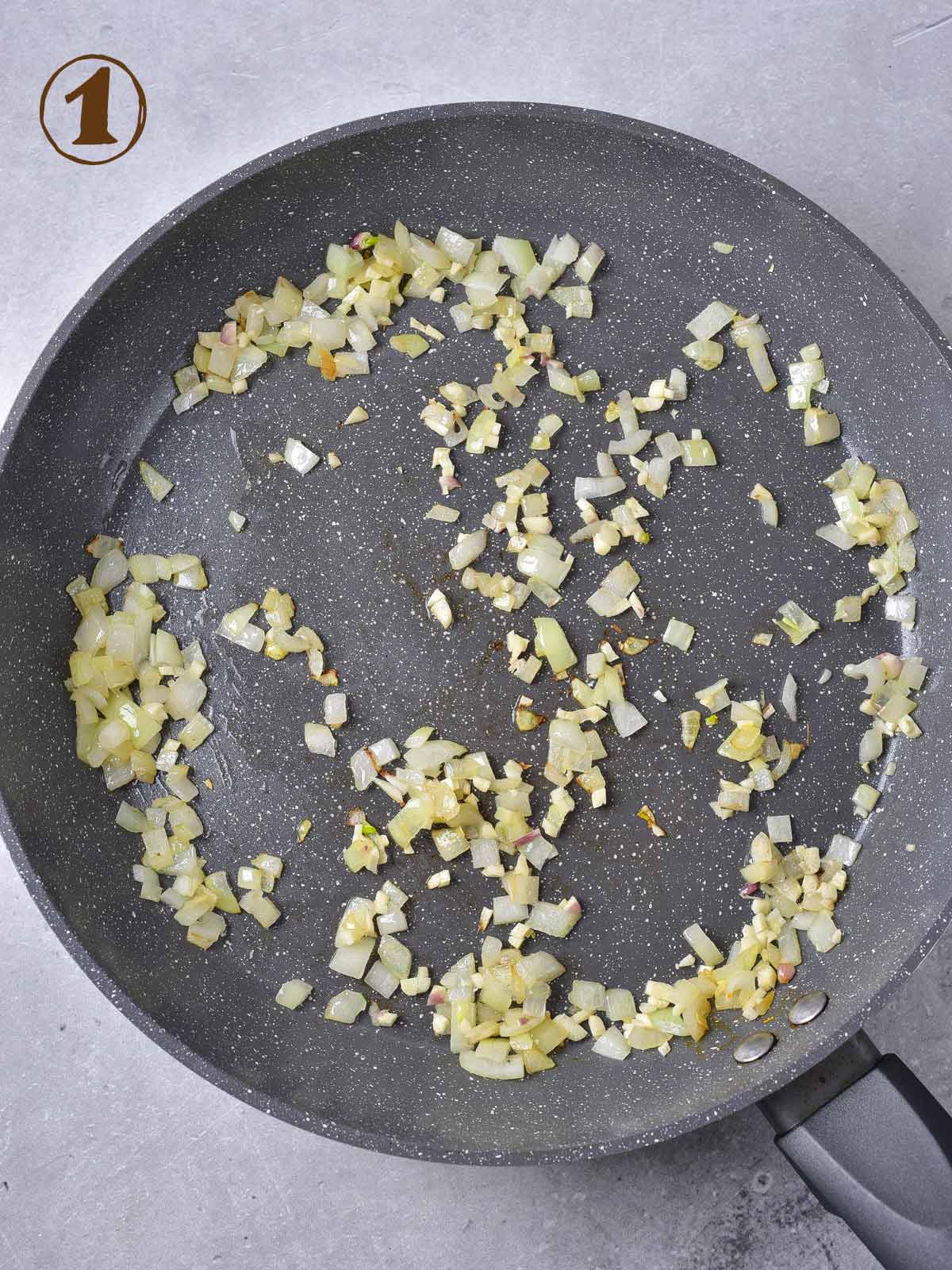 A frying pan with onions in it.