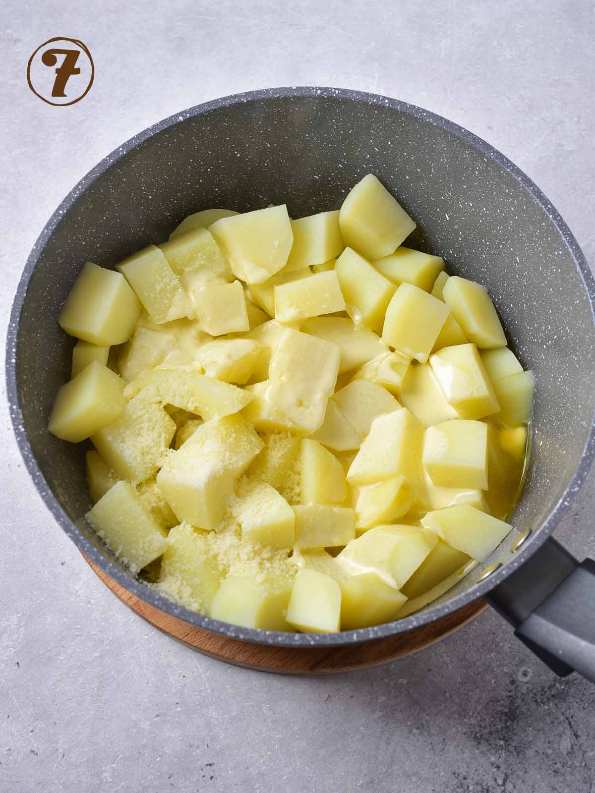 Sliced potatoes in a pan on a white background.