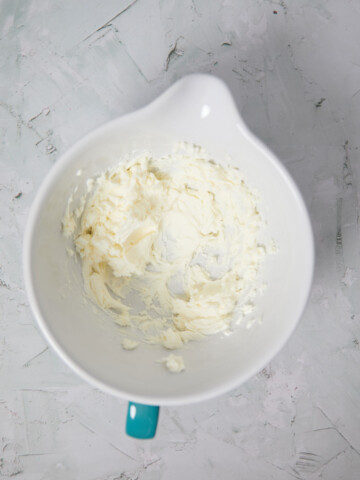 Mixing bowl with butter and cream cheese creamed together.