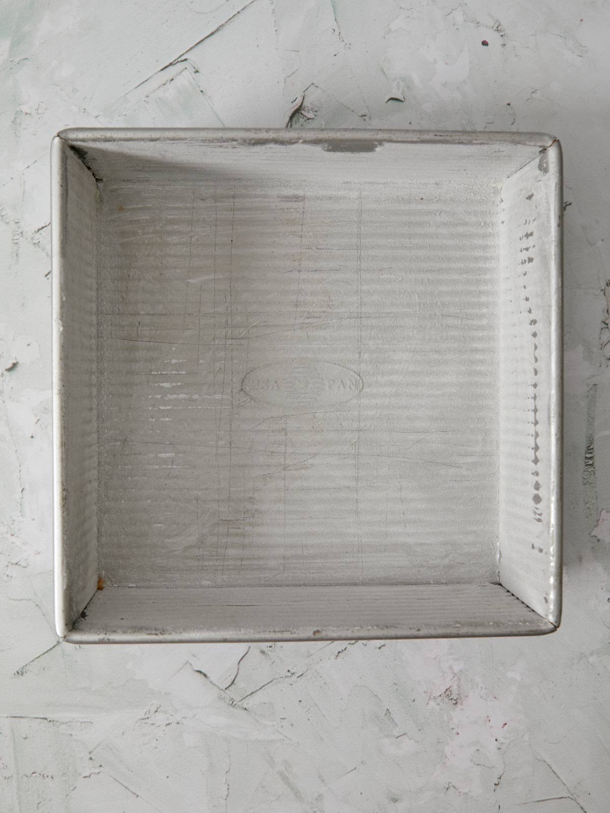 Buttered and floured baking pan.