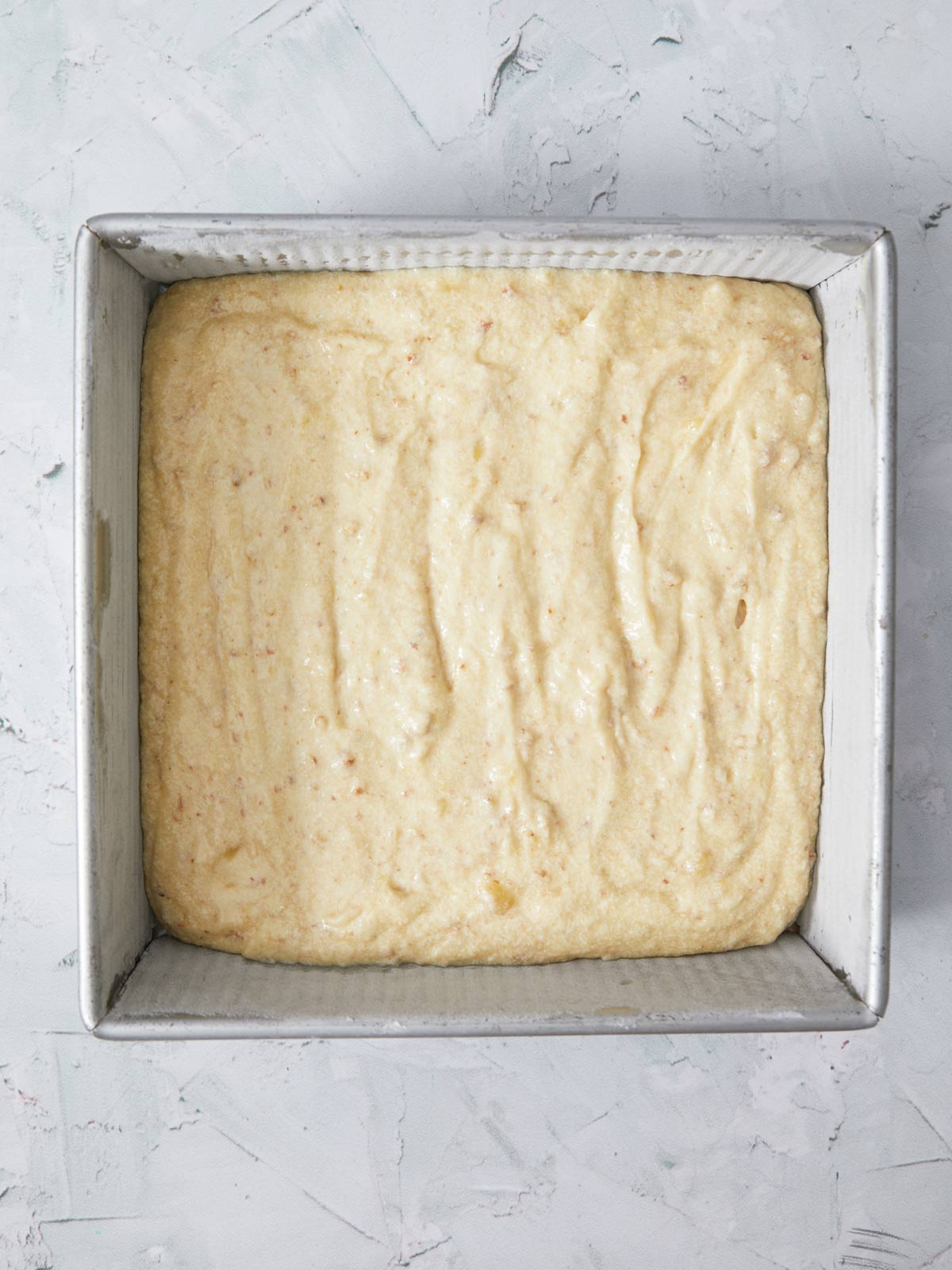 Cake batter poured into the prepared cake pan.