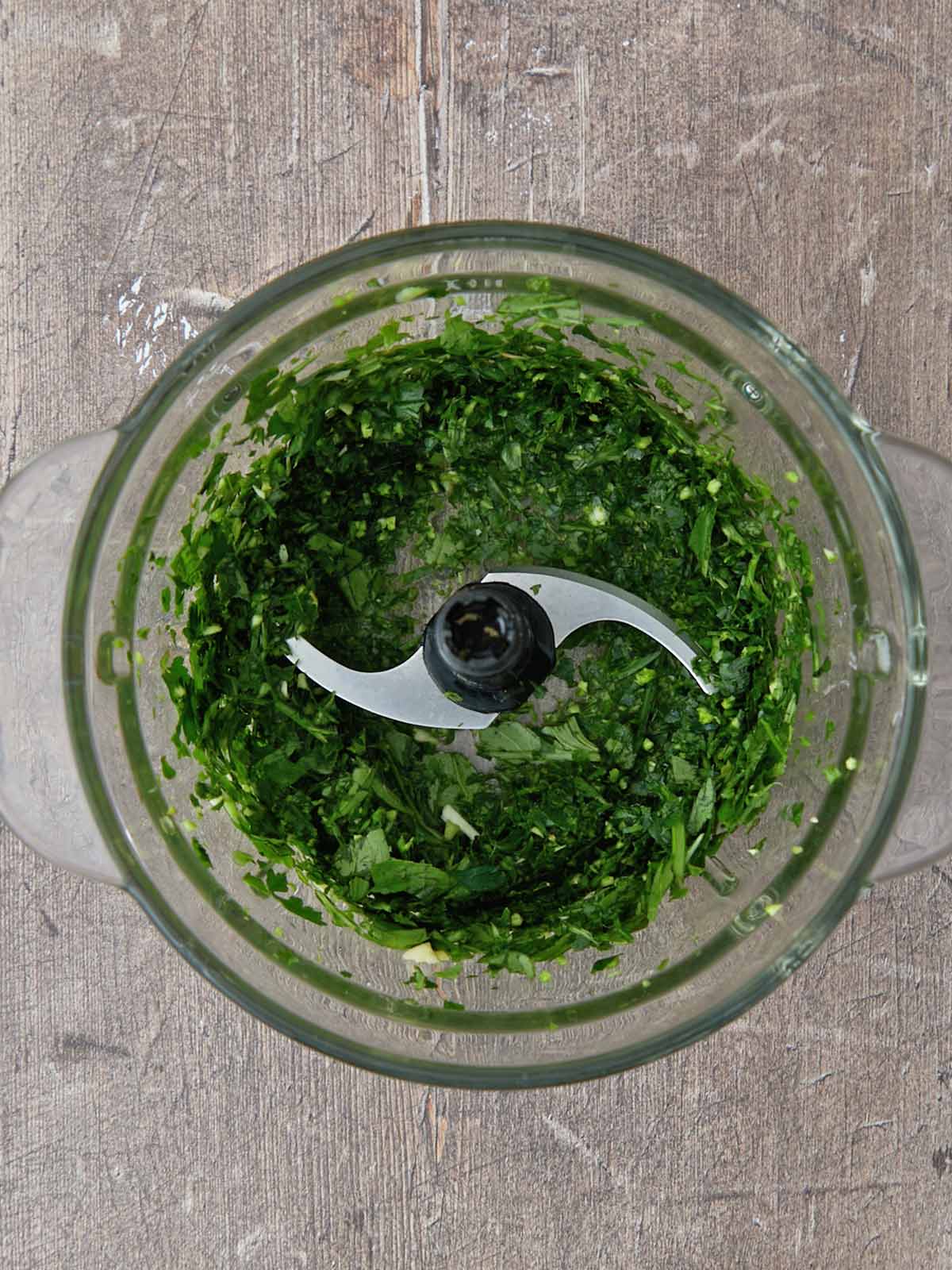 Herbs pulsed in the food processor.