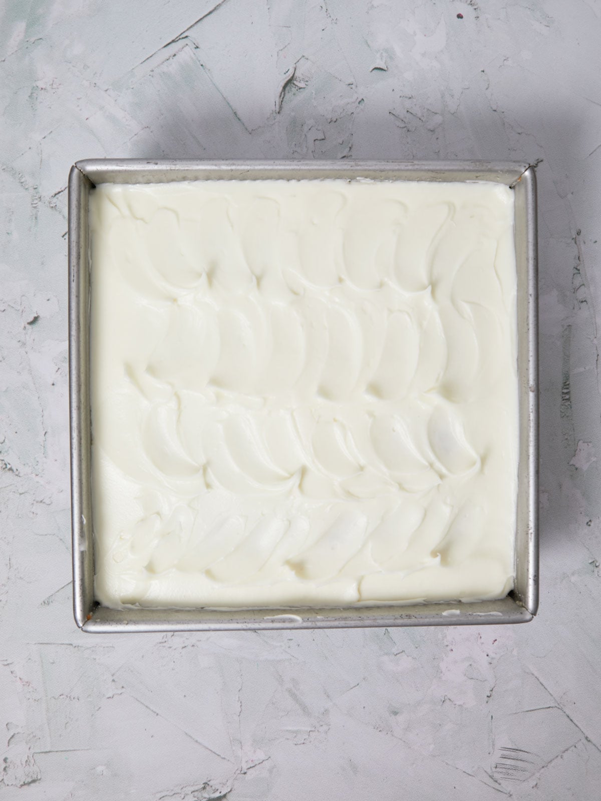 Cake frosted with cream cheese frosting.
