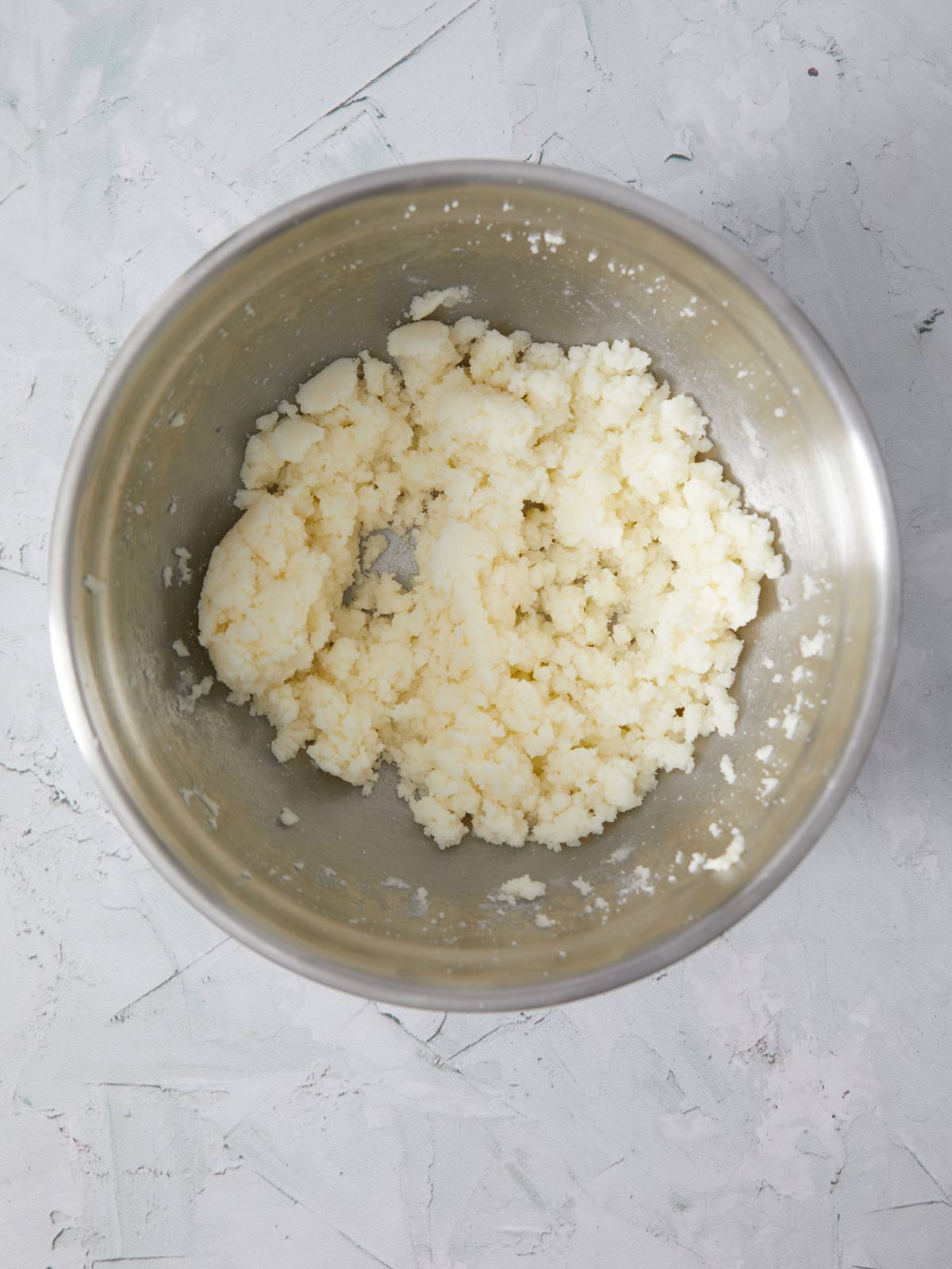 Vanilla added to the bowl with the butter and sugar.