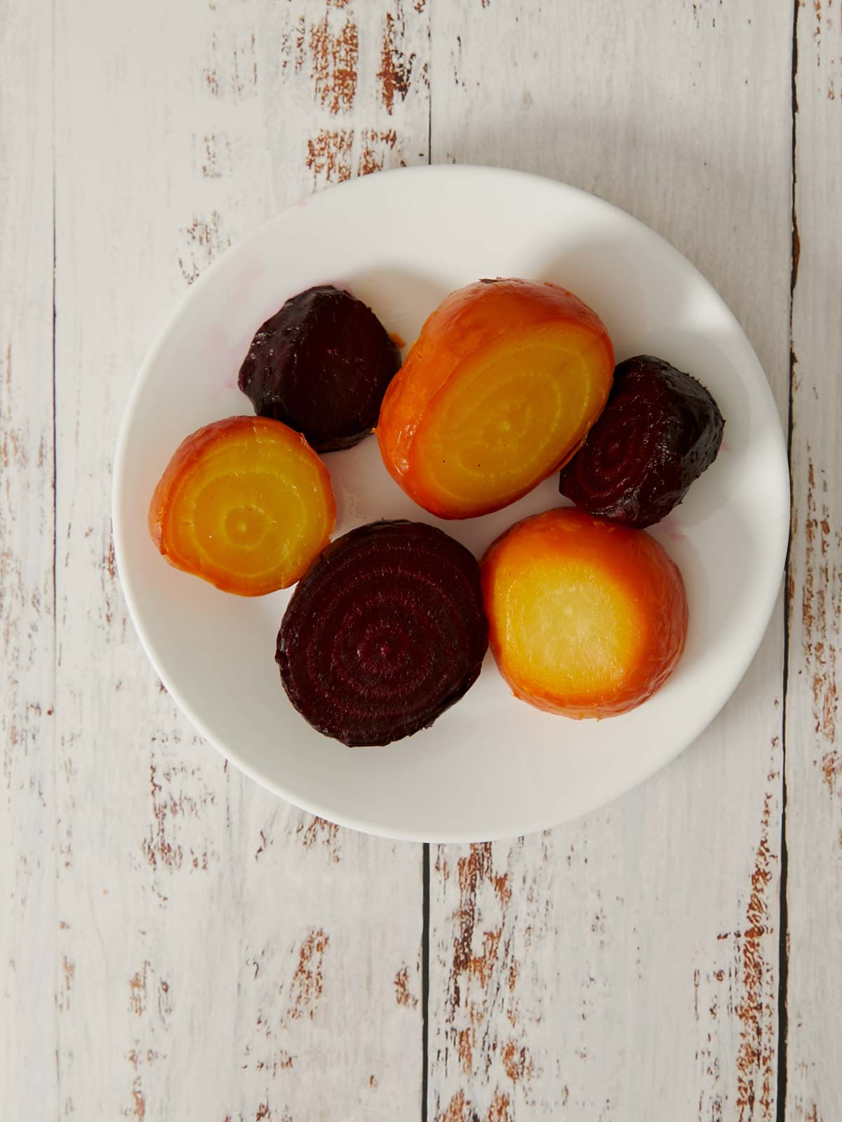 Peeled roasted beets in a bowl.