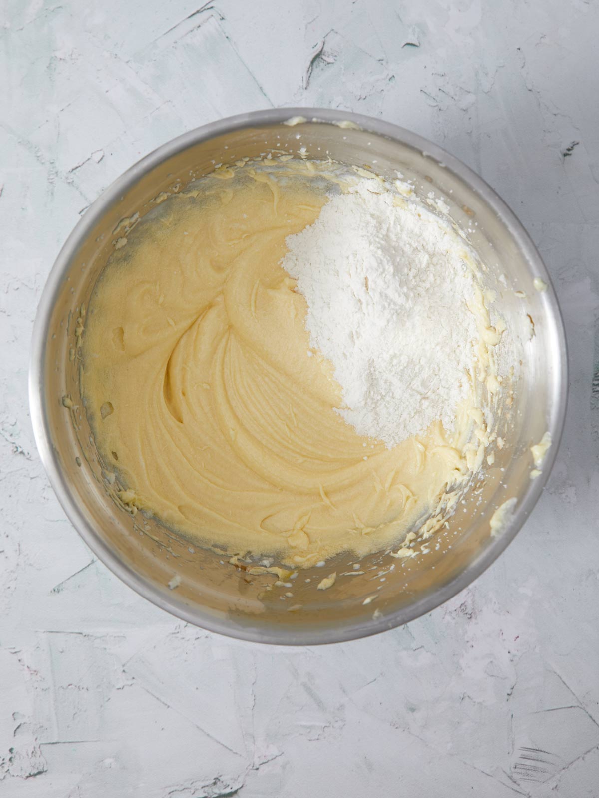 Flour poured into the mixing bowl with the other ingredients.