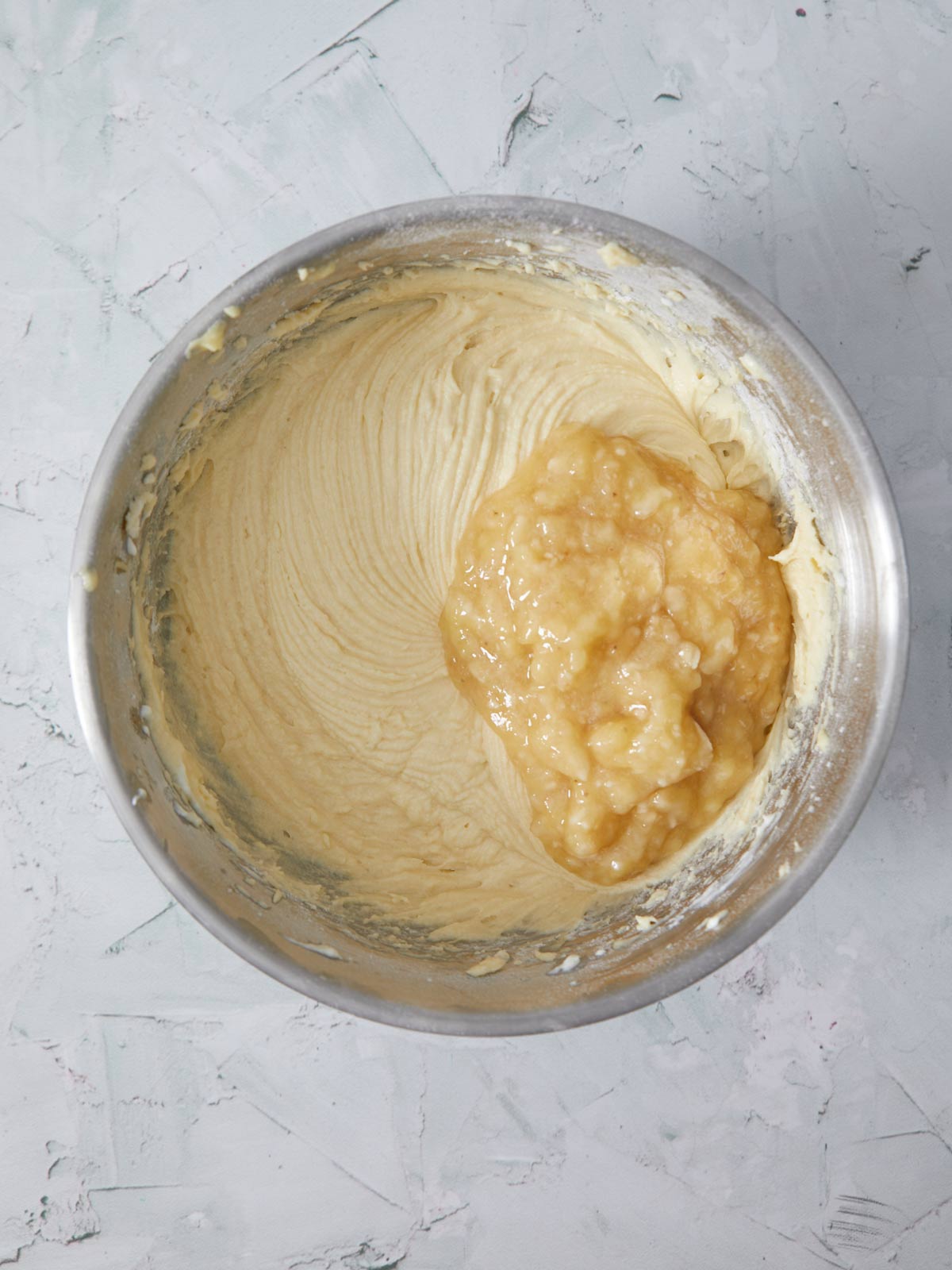Masked bananas and lemon juice added to the mixing bowl.