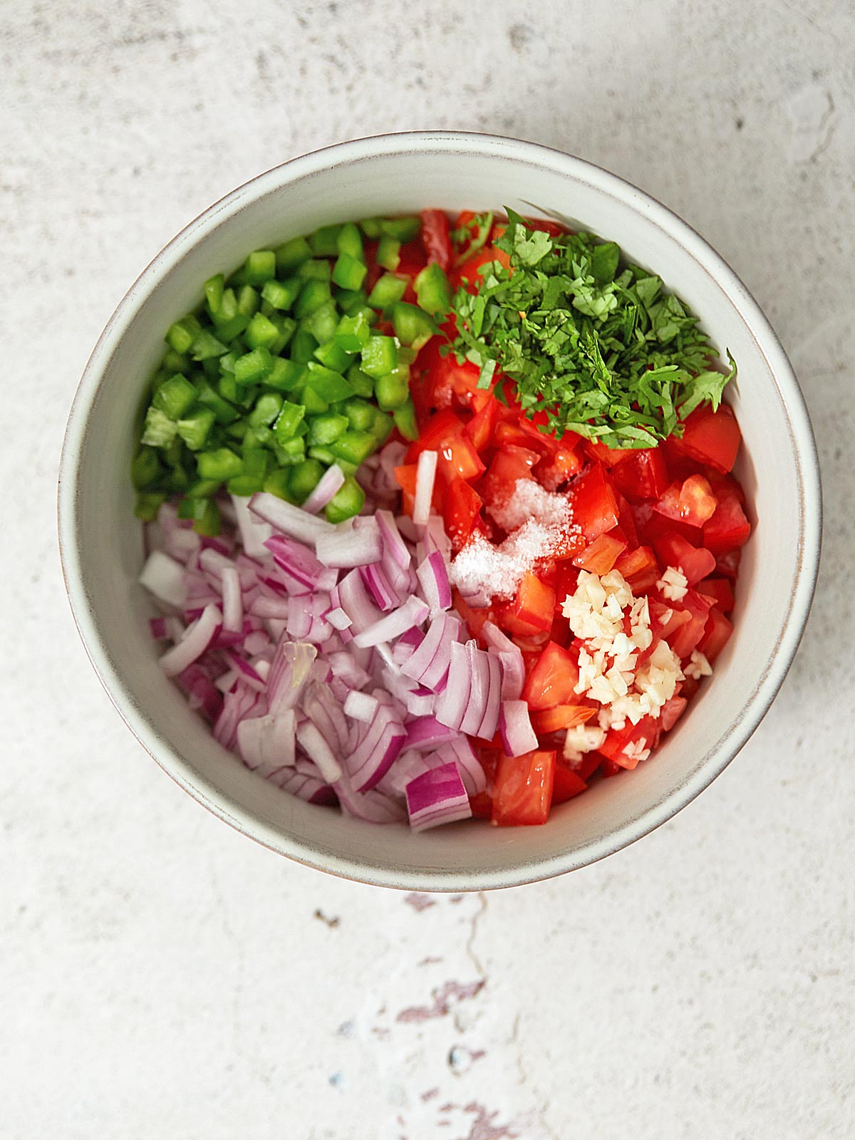 Bowl of chopped ingredients for pico de gallo.