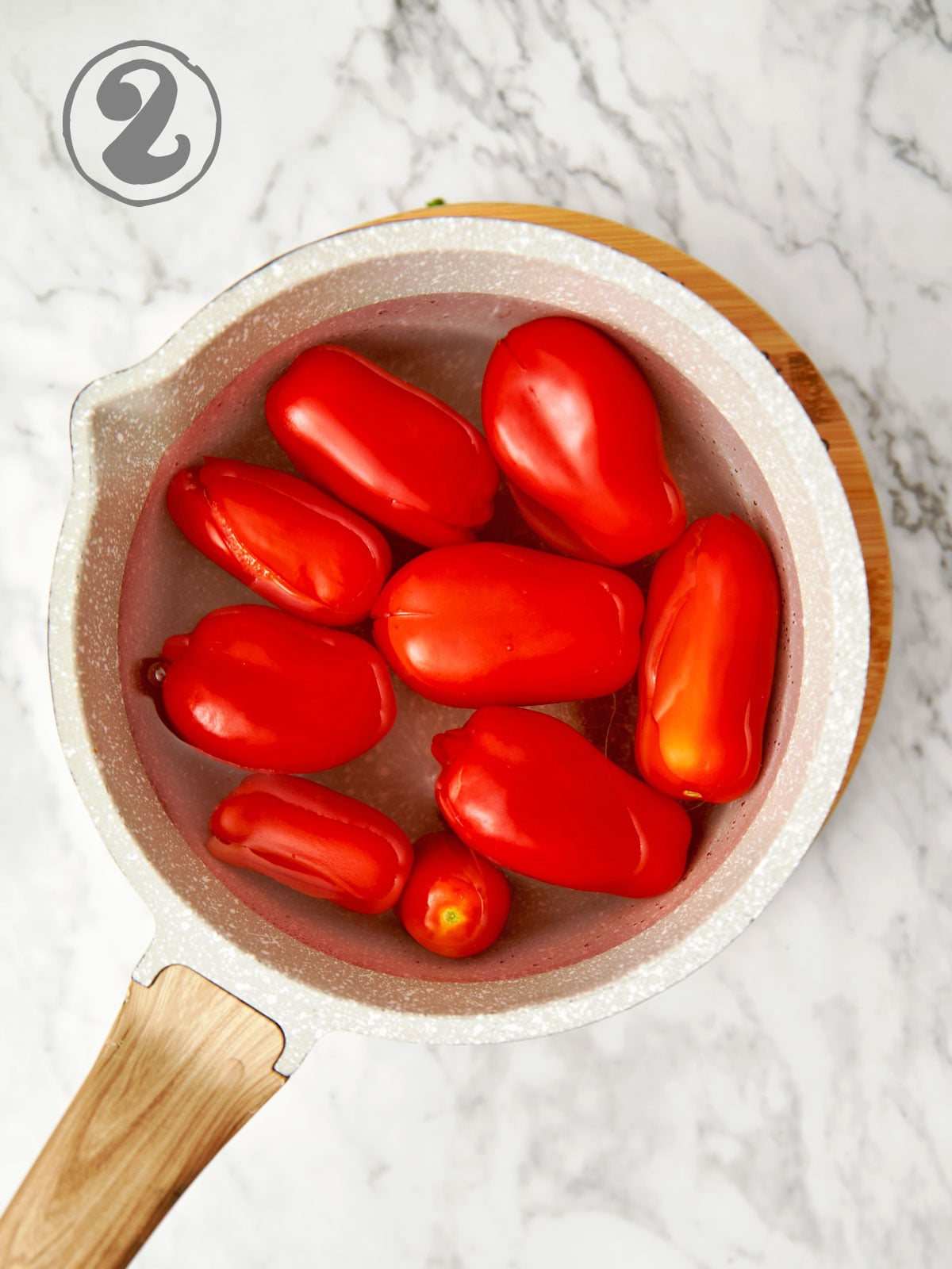 Tomatoes in pot of boiling water.