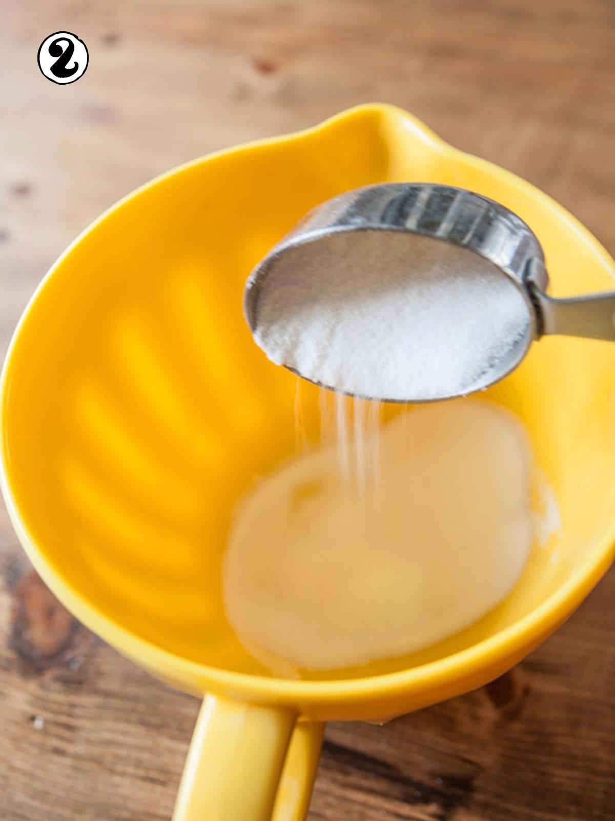 Sugar pouring into mixing bowl.