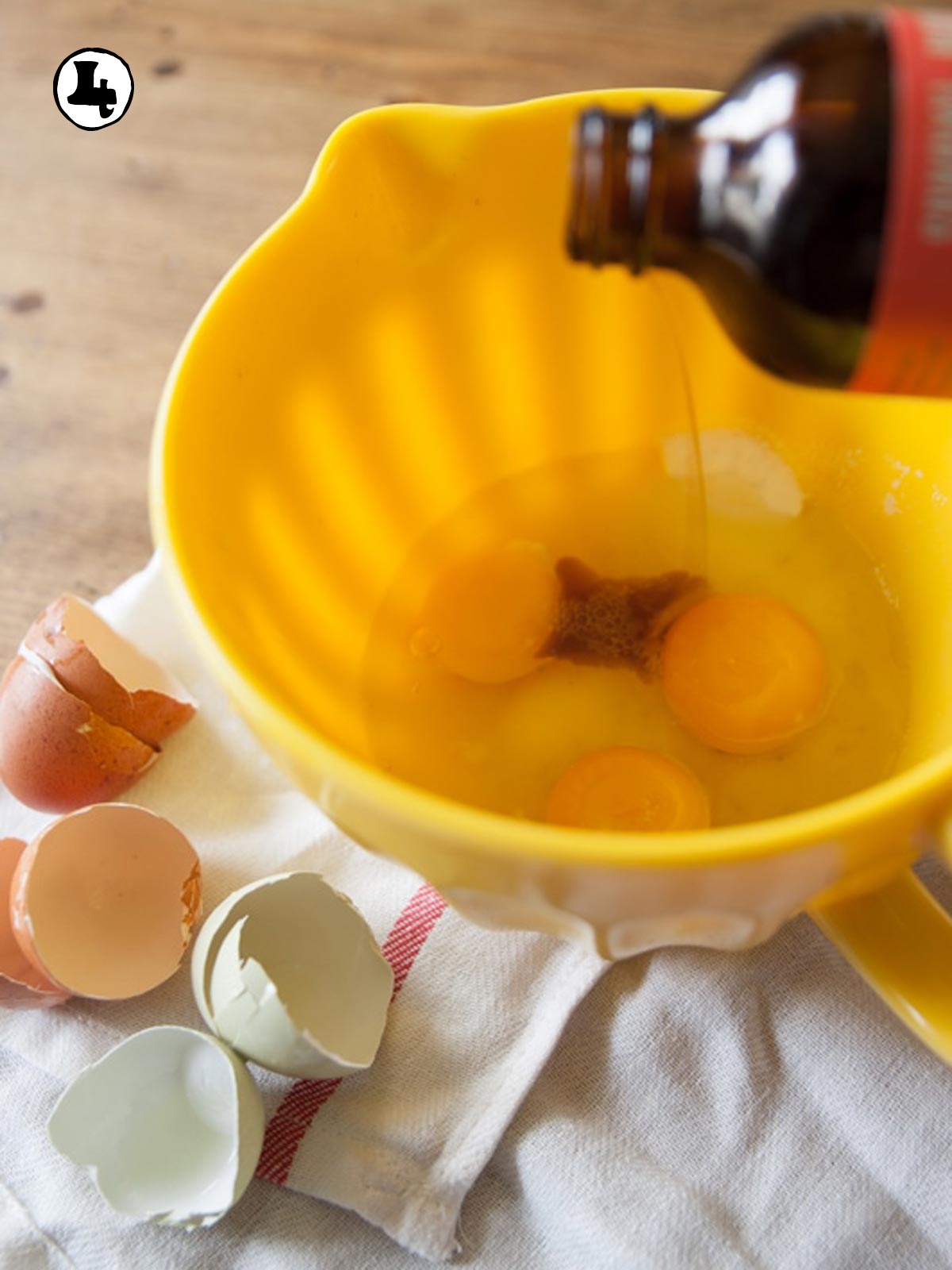 Vanilla being added to the mixing bowl.