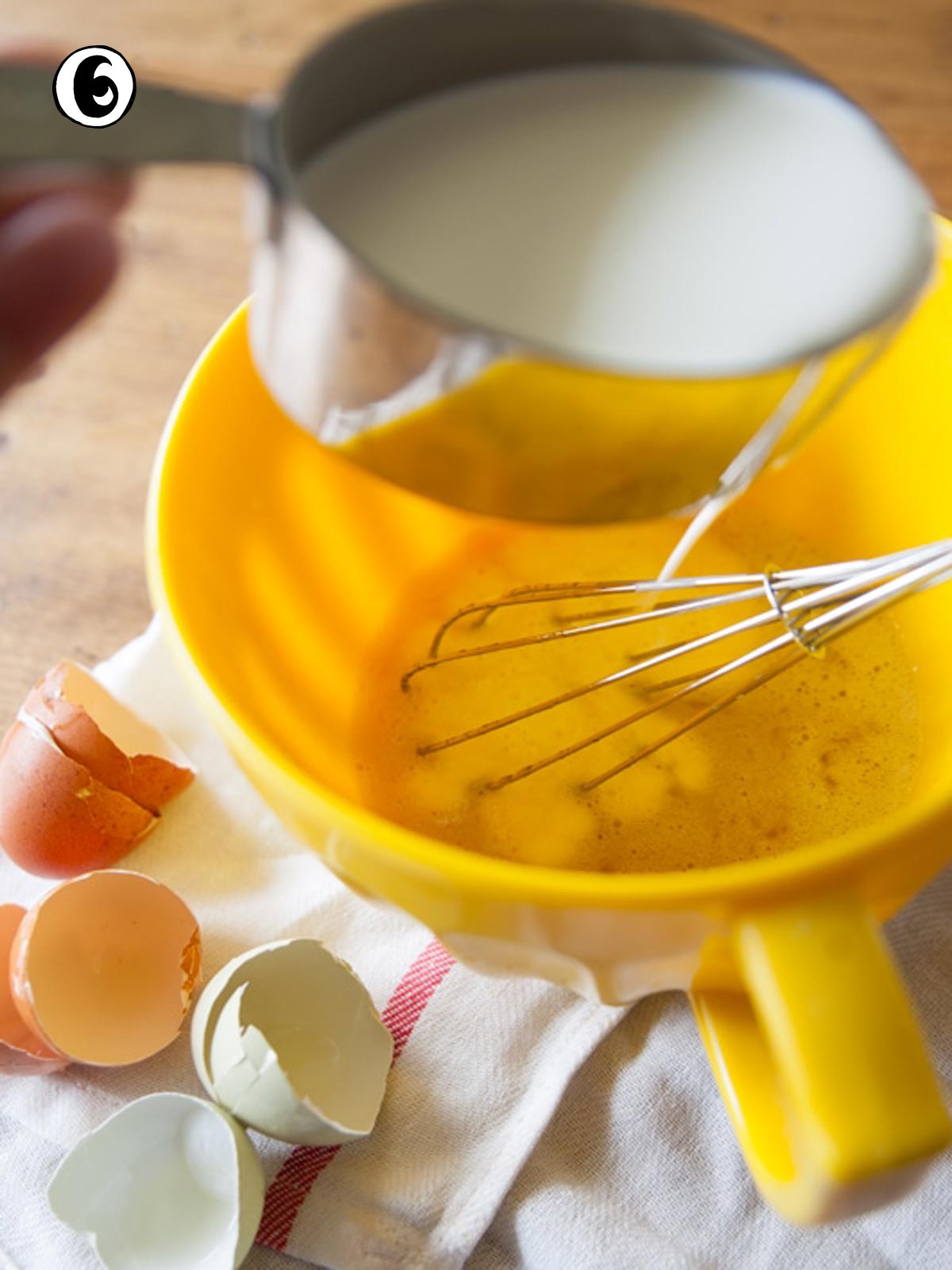 Pouring half and half into the whisked mixture.