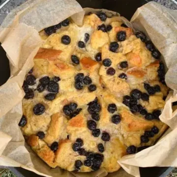 A blueberry bread pudding in a skillet.