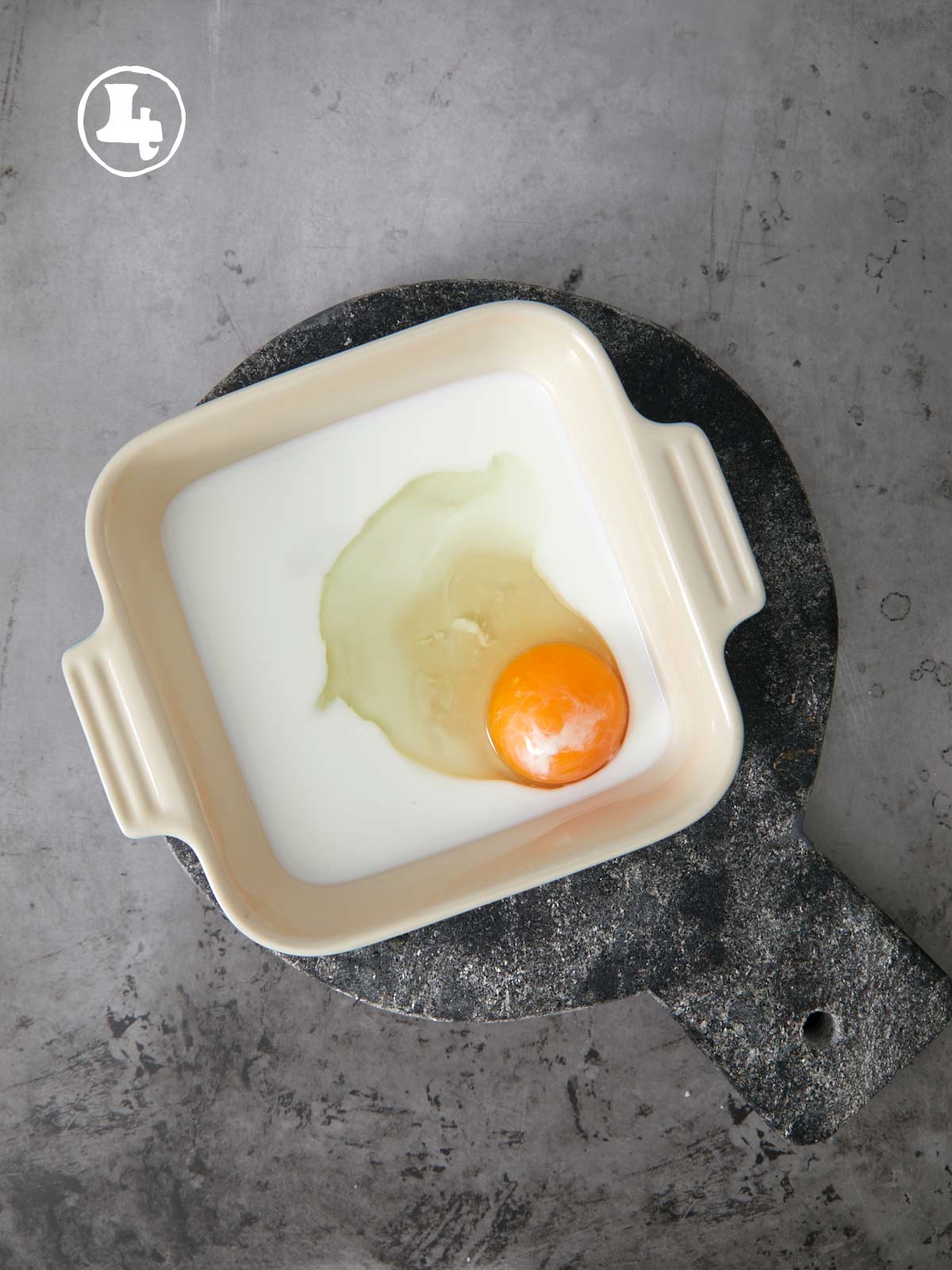 A dish with an egg and buttermilk in it.
