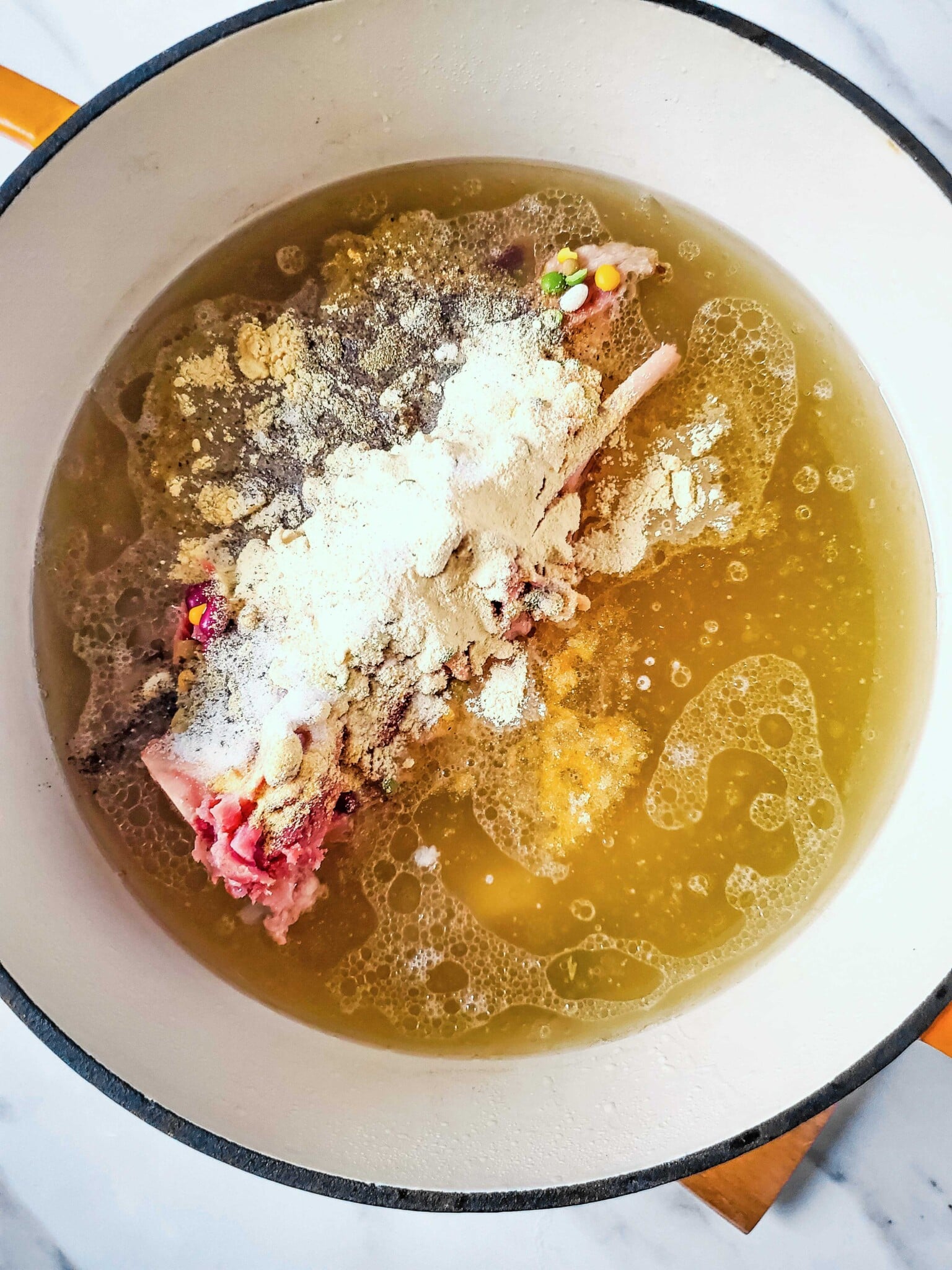 A pot with a mixture of ingredients, in it.