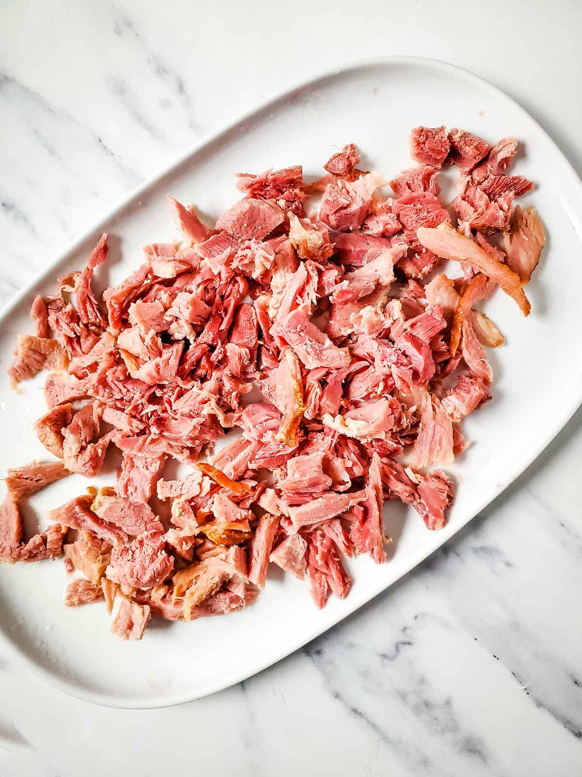 A plate of chopped meat on a marble table.