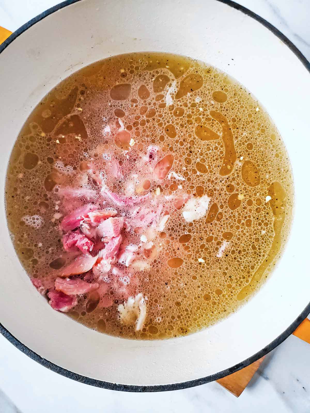 Meat and vegetables cooked in a pot.