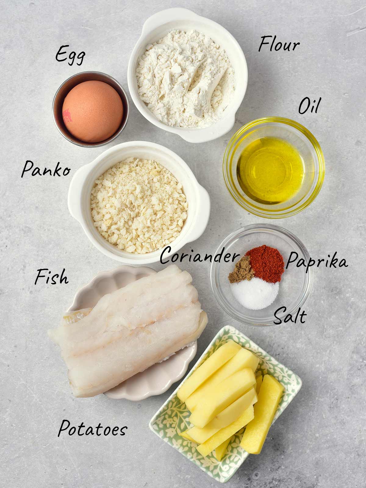 The ingredients for a fish dish are shown on a grey background.
