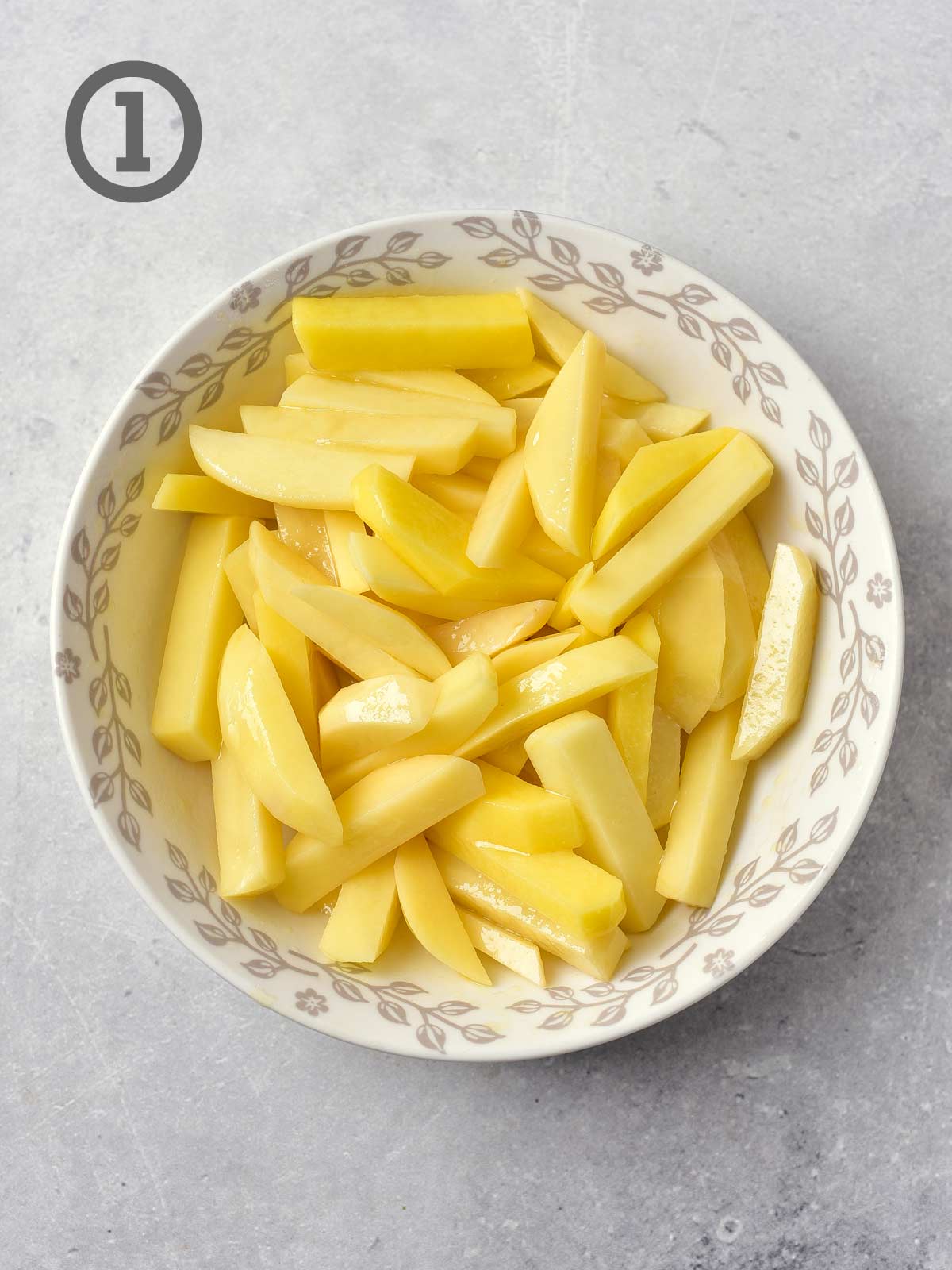 A bowl of sliced potatoes with the number 1 on it.