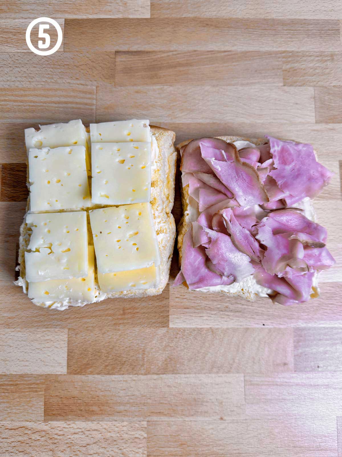 Honey baked ham and cheese sliders on a wooden table.