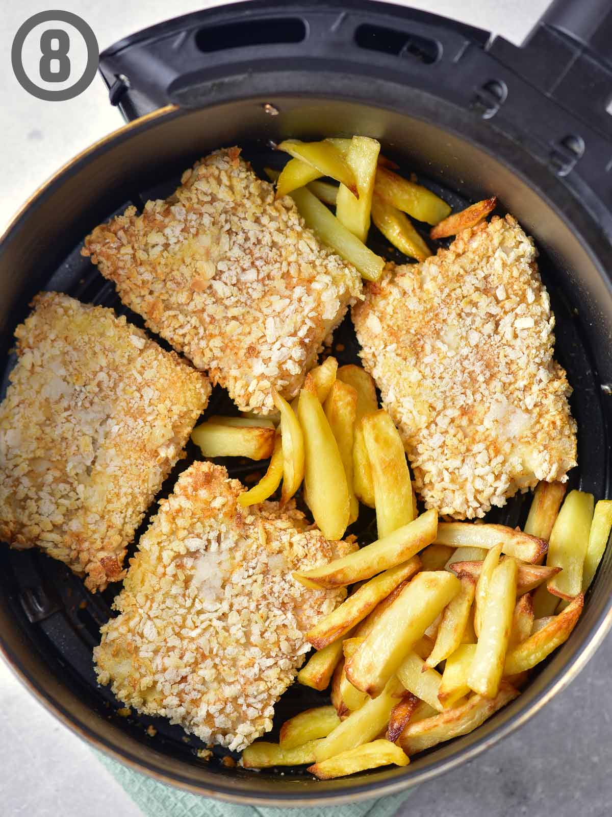 Fried fish and fries in an air fryer.