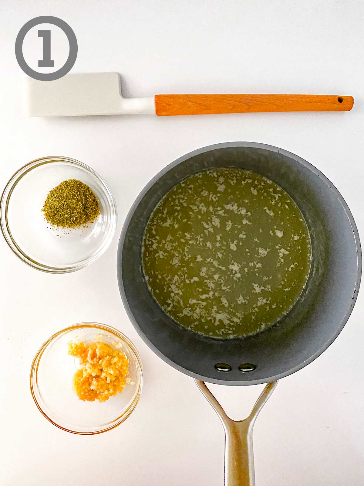 A saucepan with ingredients and a spatula.