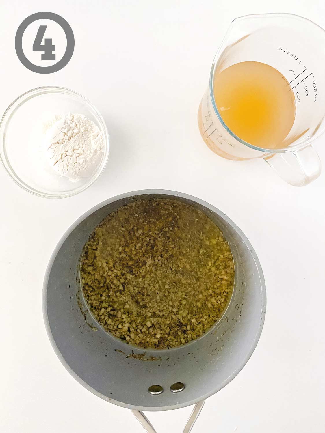 A bowl with ingredients and a measuring cup on a white surface.