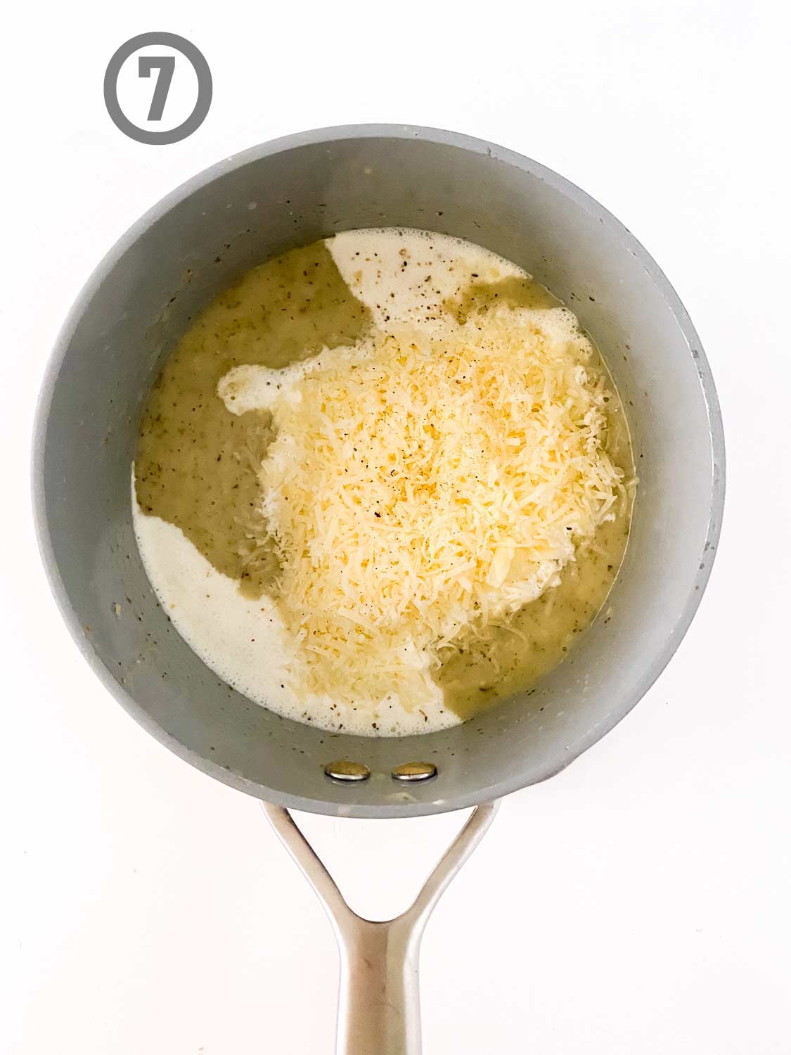 A saucepan with garlic Parmesan cheese ingredients in it.