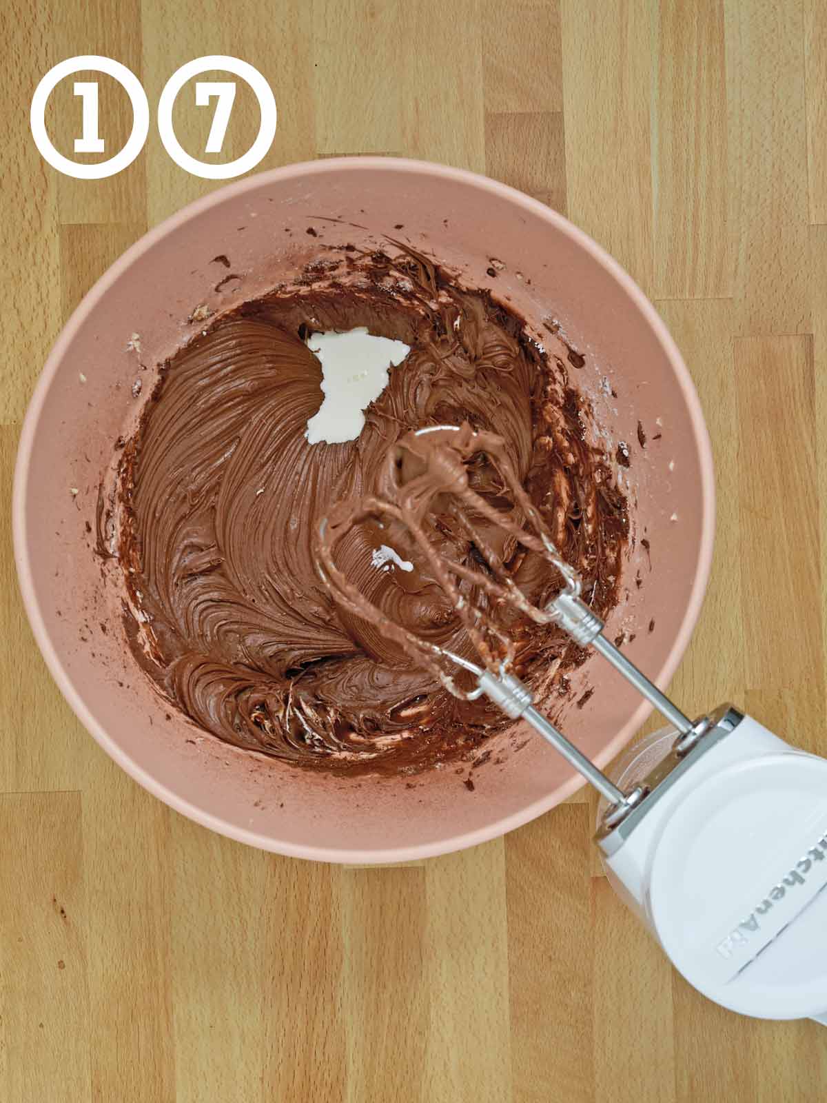 A bowl of rich chocolate frosting with heavy cream poured in.