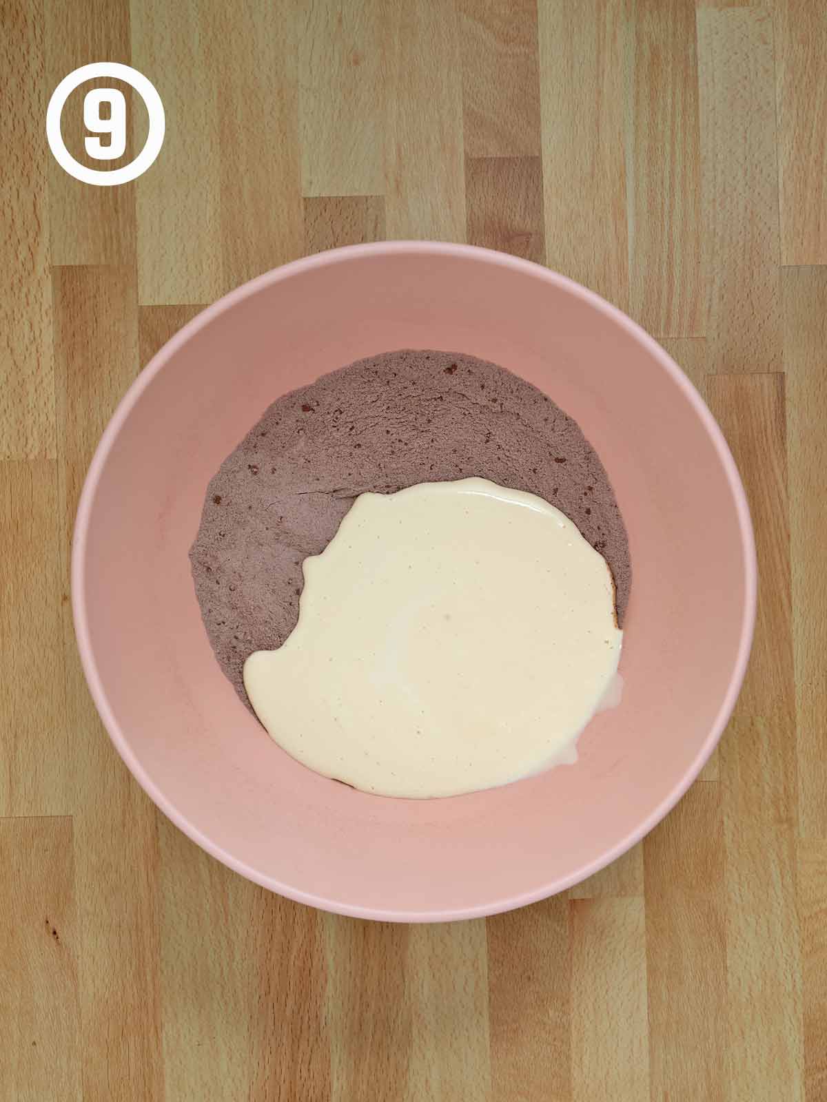 A pink bowl with the wet and dry ingredients.