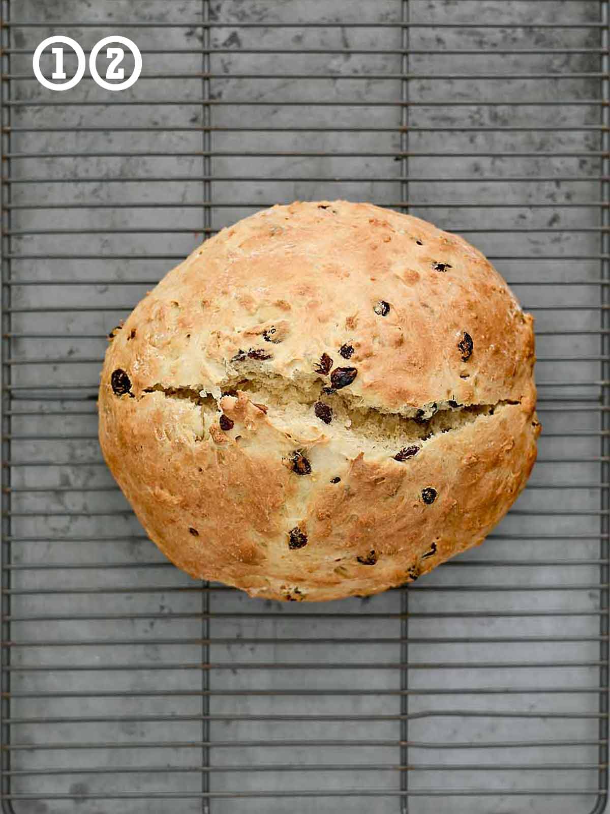 A loaf of bread on a cooling rack.