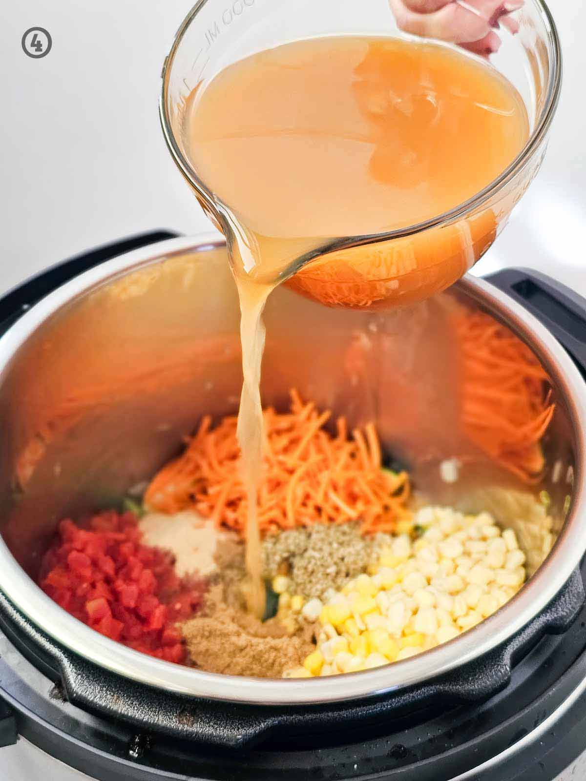 A bowl of Mexican Vegetable Soup being poured into a pot of food.