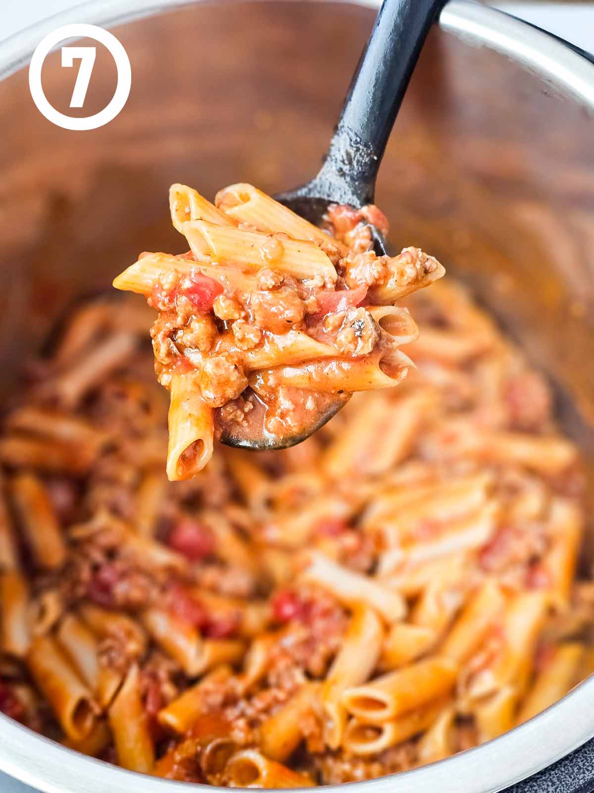 A spoonful of pasta in an instant pot.