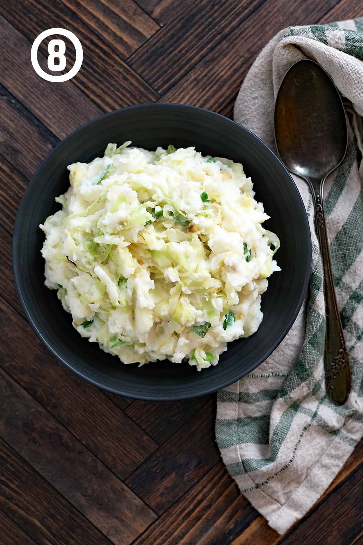 Irish colcannon in a bowl on a wooden table.
