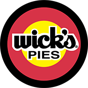 Wick's Pies logo with white text on a yellow circle, surrounded by red and black concentric circles-perfect for anyone craving a Mango Pie or searching for the best recipe mango pie has to offer.